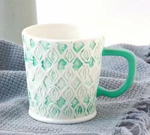 Rubbed embossed ceramic mug
